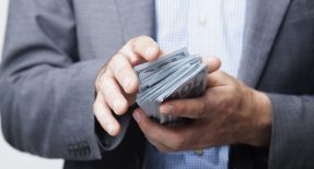A Payday Cash Advance Makes Funds Available Fast Man holds paycheck advance cash